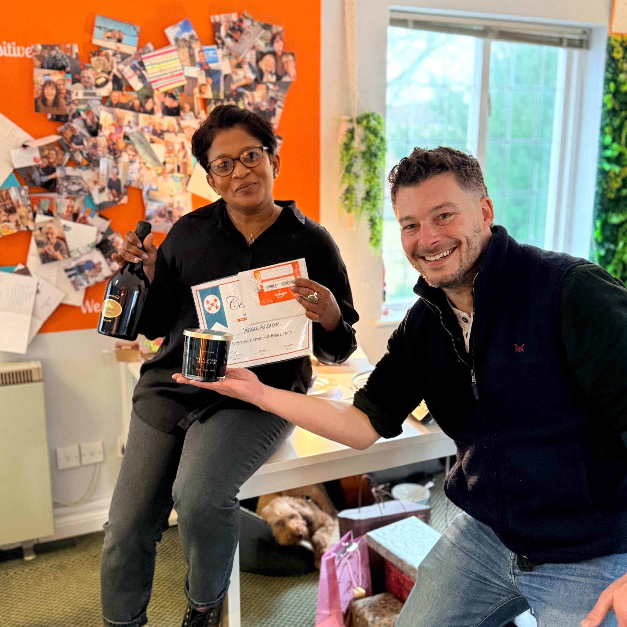 Ishara receiving her five-year anniversary certificate from Chris